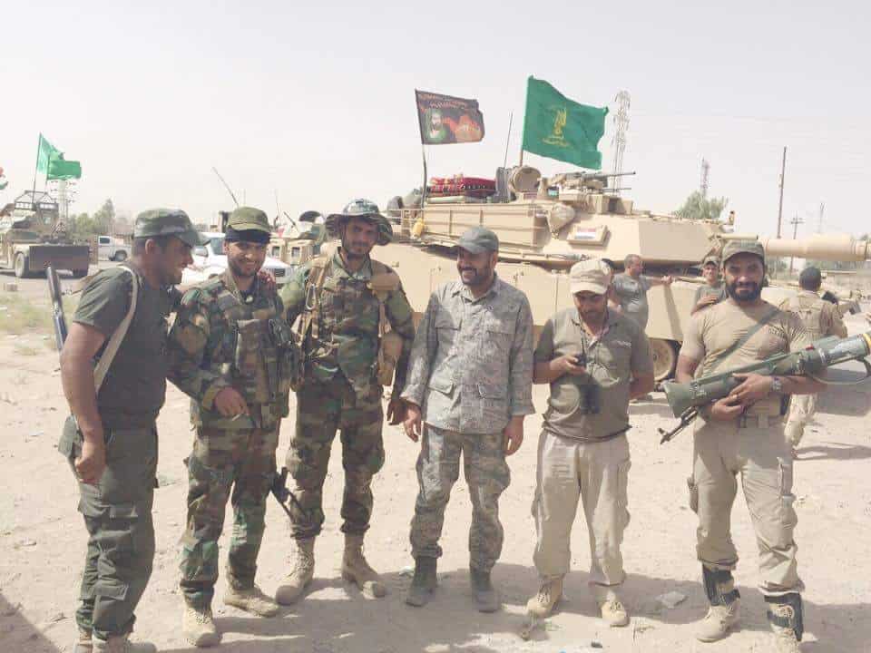 Badr Organization fighters pose with US M1 Abrams tank